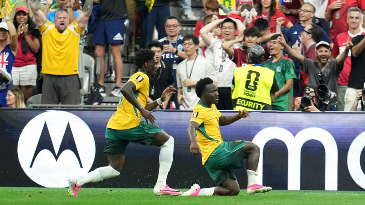 Australia's Nestory Irankunda, right, celebrates with Mohamed Toure (9) after scoring their opening goal during the World Cup Group D soccer match between Australia and Turkey in Vancouver, British Columbia, Saturday, June 13, 2026. (AP Photo/Abbie Parr)