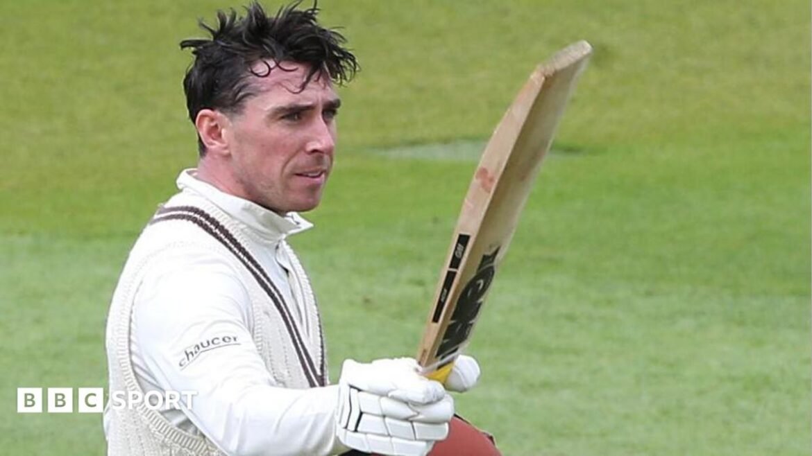 Dan Lawrence raises his bat