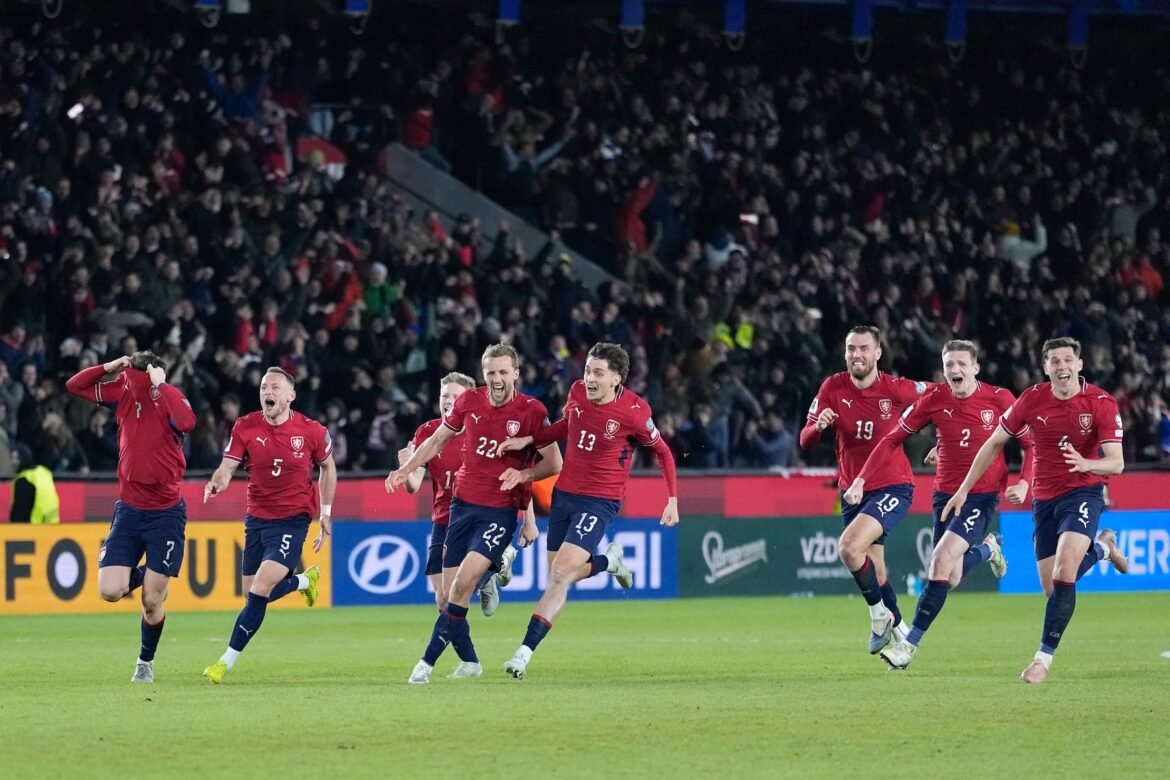 Czechia players celebrate after winning a penalty shootout at the end of the World Cup qualifying playoff final soccer match between Czechia and Denmark in Prague, Tuesday, March 31, 2026. (AP Photo/Petr David Josek)