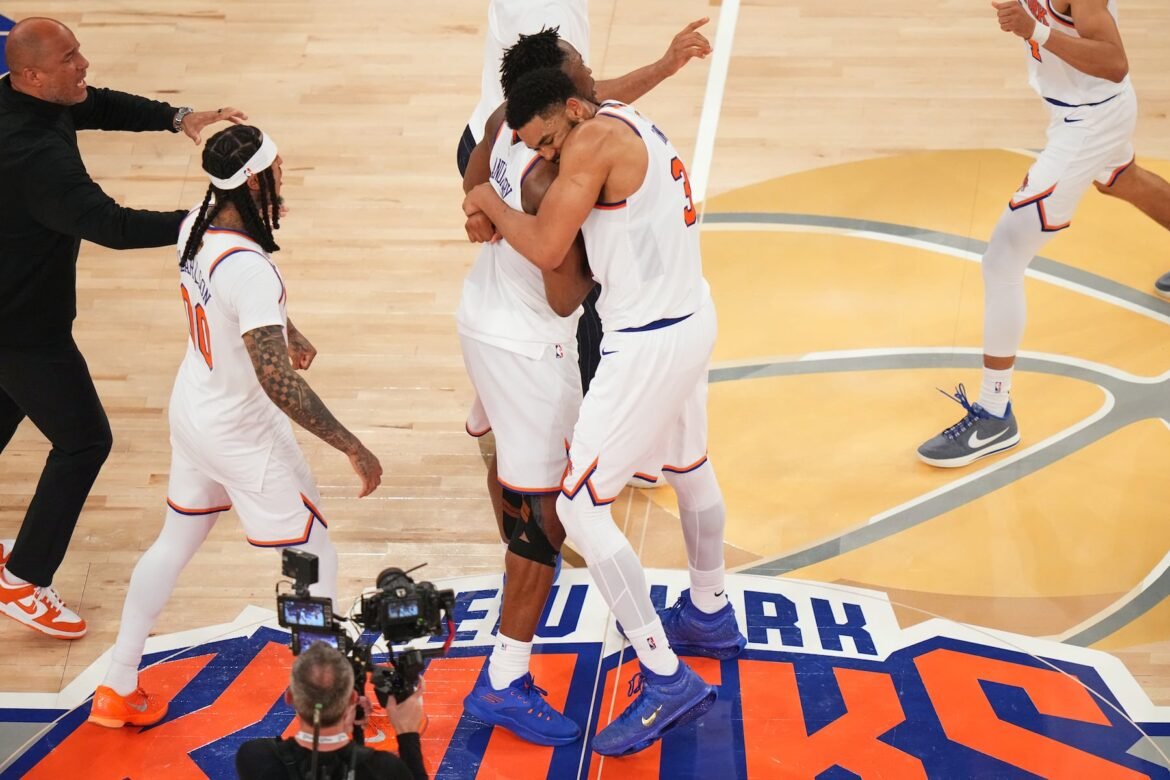 New York Knicks center Karl-Anthony Towns (32) hugs forward Og Anunoby (8) after the team's victory over the San Antonio Spurs in Game 4 of the NBA Finals basketball series, Wednesday, June 10, 2026, in New York. (AP Photo/Frank Franklin II)