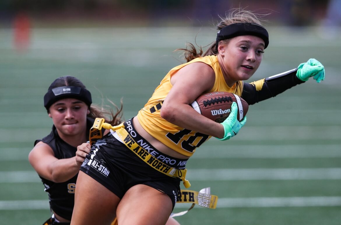 Molly Smyth (10) of North tries to slip past Gabriella Gonzalez (6) of South during the 2026 Phil Simms North South Flag Football Classic at The College of New Jersey in Ewing, NJ on 6/20/26.