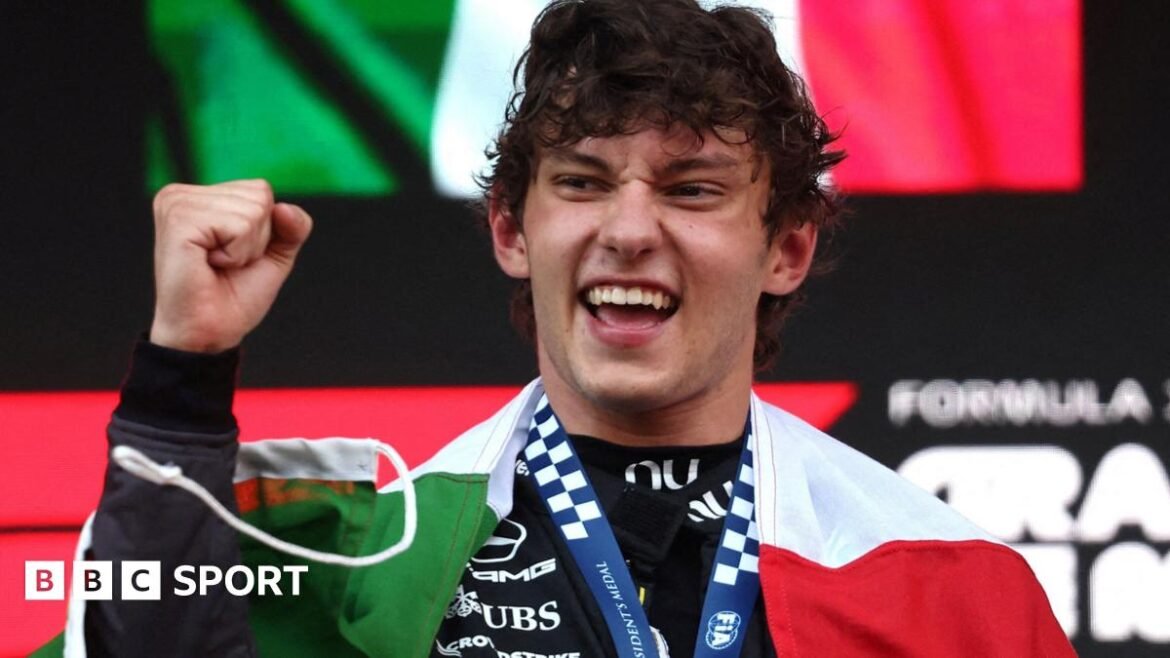 Kimi Antonelli with the Italian flag draped around his shoulders after winning the Monaco Grand Prix
