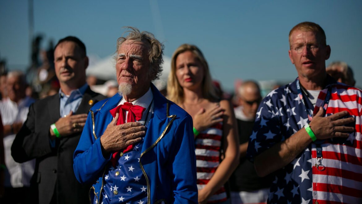 WILMINGTON, NC - SEPTEMBER 23: People says the pledge of allegiance before a Save America rally for former President Donald Trump at the Aero Center Wilmington on September 23, 2022 in Wilmington, North Carolina. The "Save America" rally was a continuation of Donald Trump's effort to advance the Republican agenda by energizing voters and highlighting candidates and causes. (Photo by Allison Joyce/Getty Images)