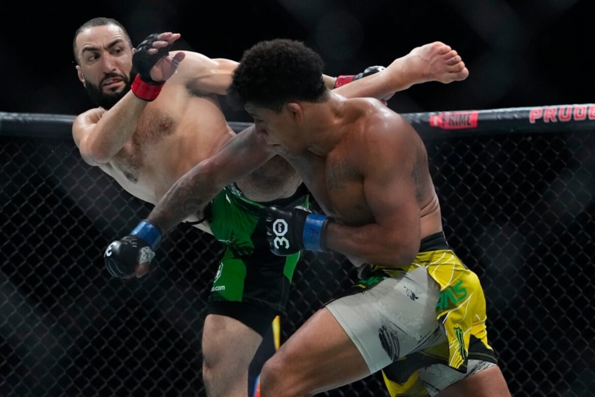 FILE - Belal Muhammad, left, kicks Brazil's Gilbert Burns during the first round of a welterweight bout at the UFC 288 mixed martial arts event, May 6, 2023, in Newark, N.J. (AP Photo/Frank Franklin II, File)