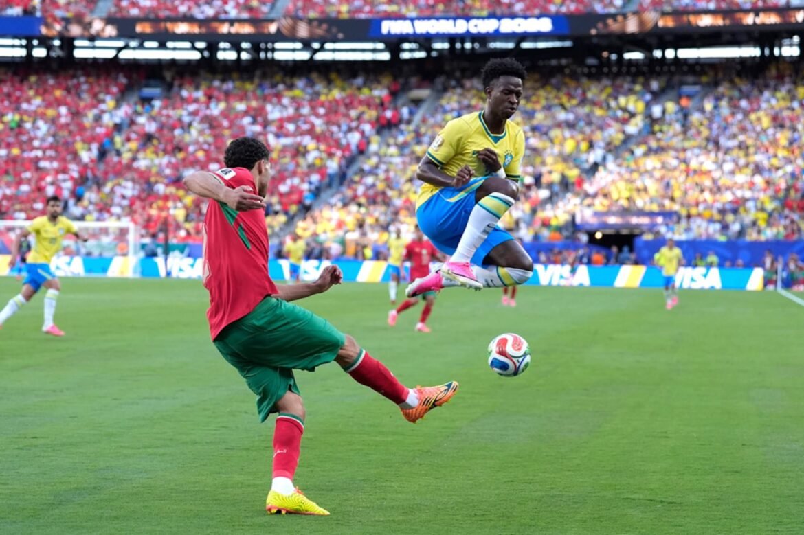 Morocco's Achraf Hakimi (2) controls the ball against Brazil's Vinicius Junior (7) during the World Cup Group C soccer match between Brazil and Morocco in East Rutherford, N.J., near New York, Saturday, June 13, 2026. (AP Photo/Yuki Iwamura)