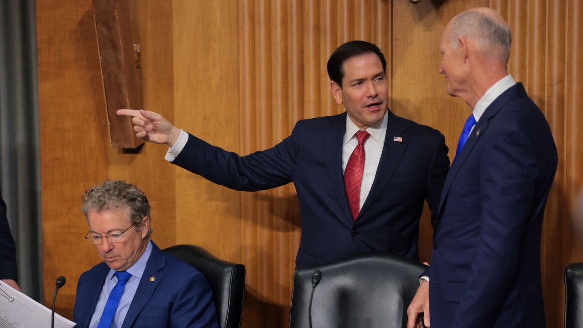 Marco Rubio is greeted by U.S. Sen. Rick Scott (R-FL) (R) as he arrives to testify during a Senate Foreign Relations Committee.
