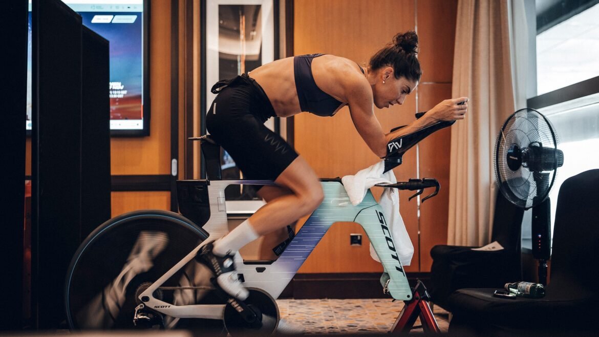 A triathlete is on a bike trainer for a lunchtime workout that builds power and leads to better climbing.