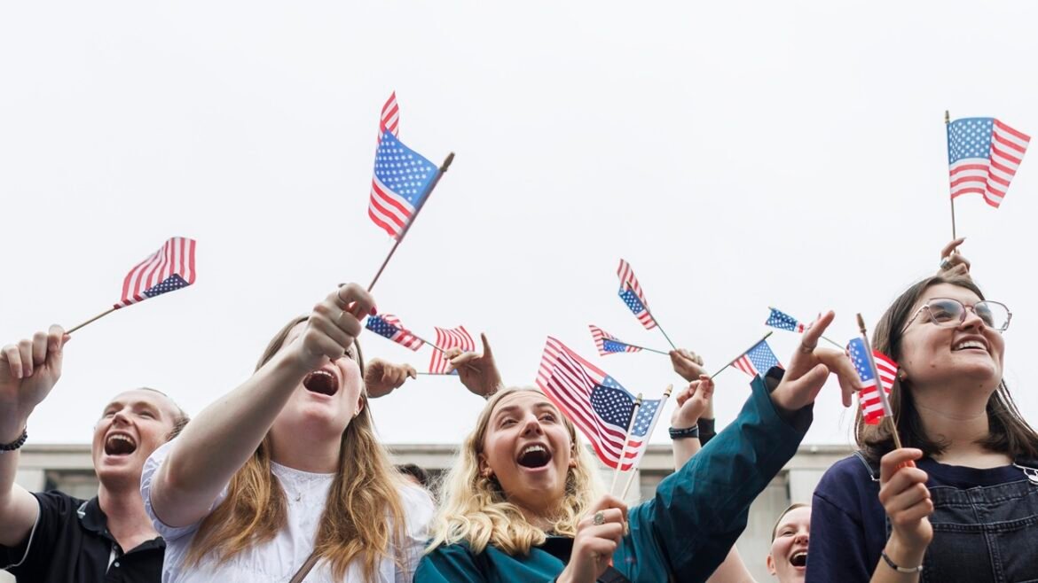 Parade attendees holding American Flags