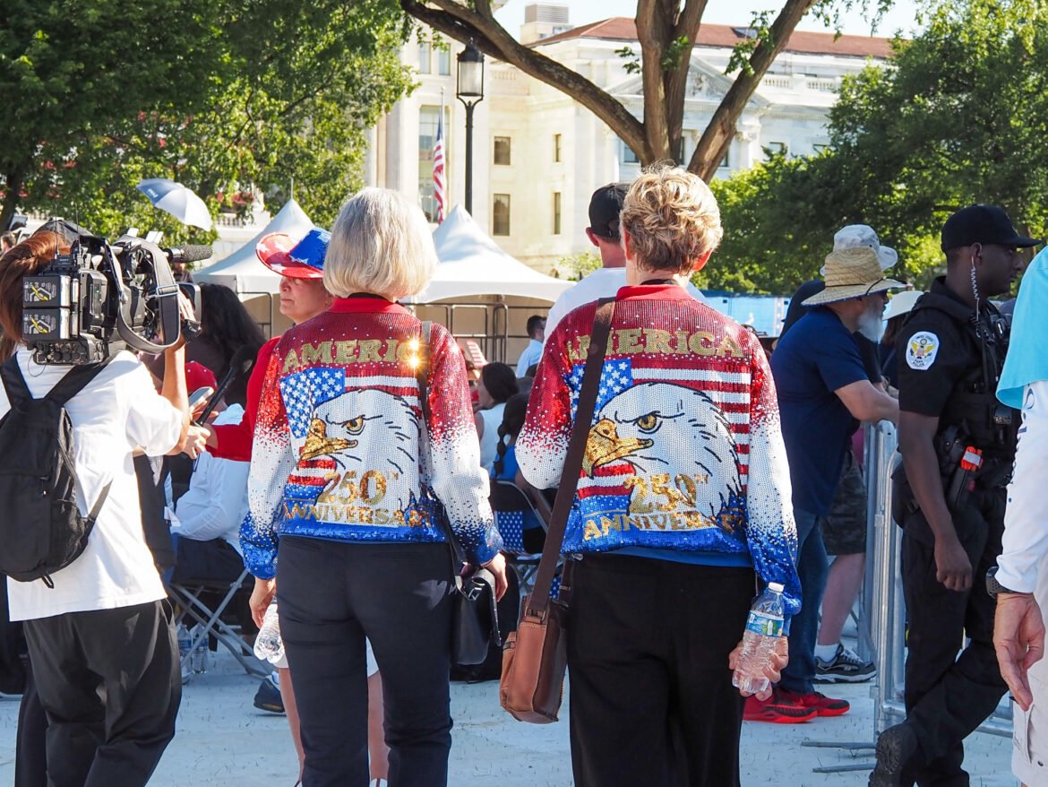 At left, Patti Gordon, 71, of Atlanta, walks with her friend from Texas at the Freedom 250 kickoff event in Washington, D.C., on Wednesday, June 24, 2026. (Photo by Ashley Murray/States Newsroom)