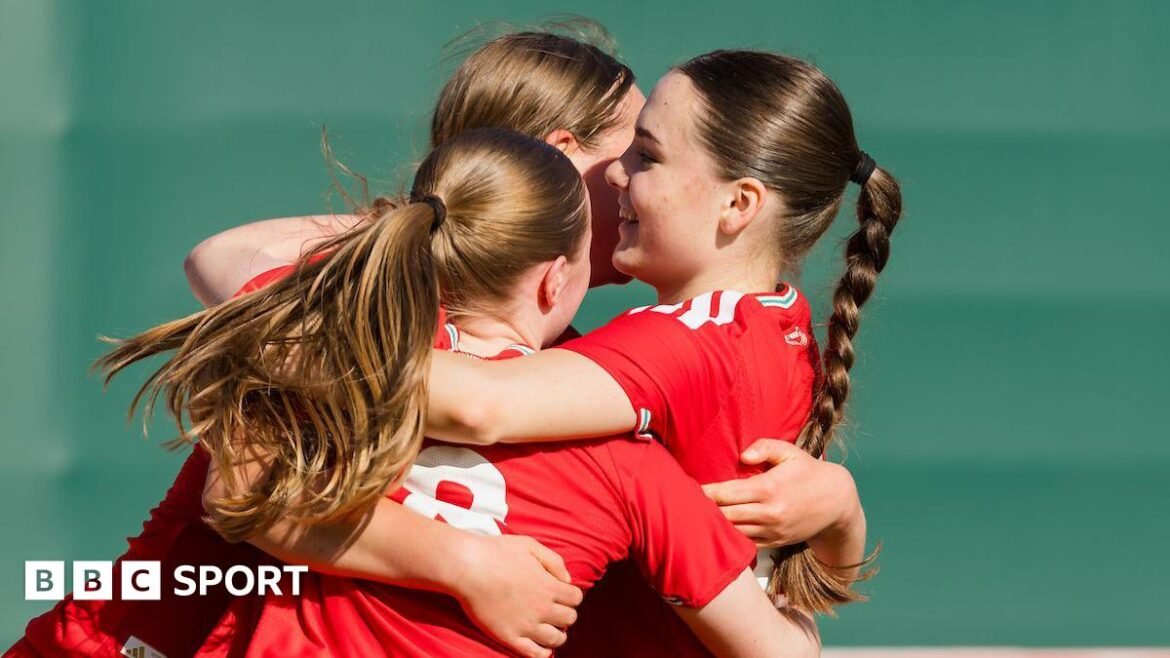 Wales' Cadi Griffiths celebrates scoring with two Wales under-17s teammates