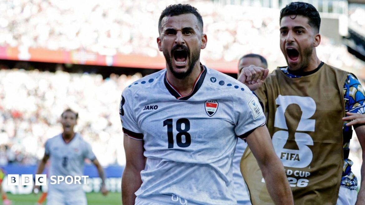 Iraq's Aymen Hussein celebrates scoring their first goal 