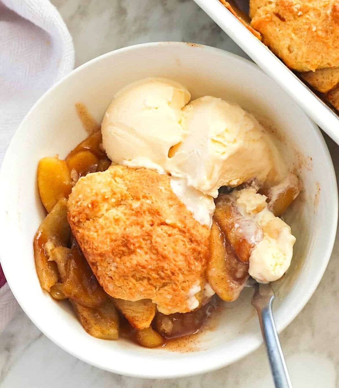 Enjoying a fresh from the oven apple cobbler with vanilla ice cream.