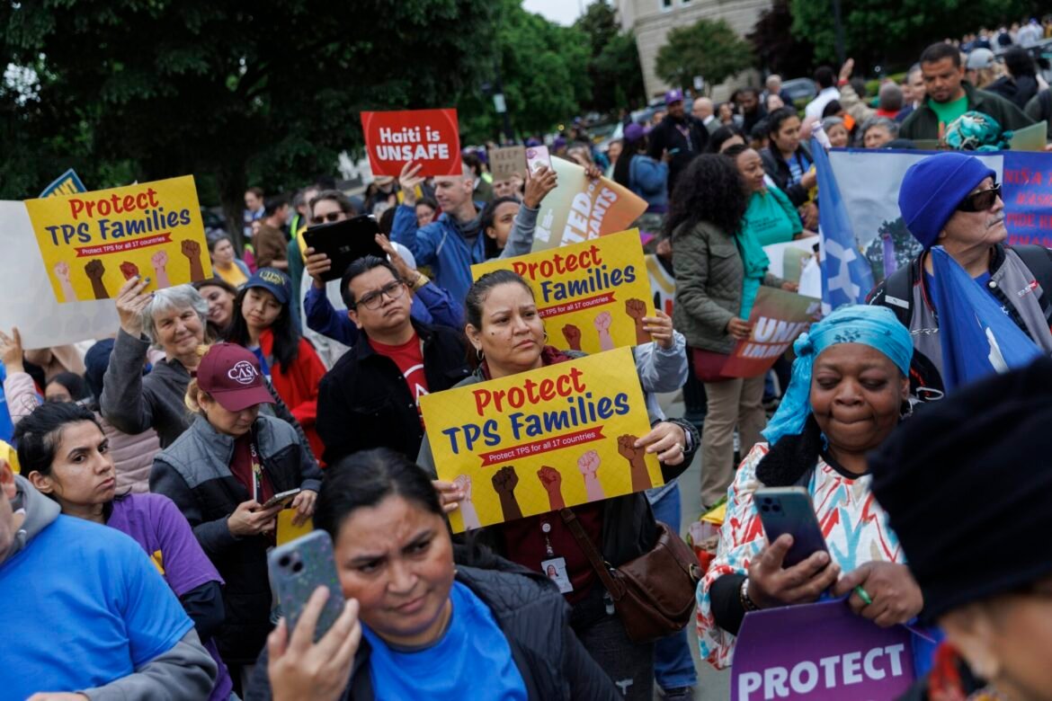 Demonstrators chant and hold signs outside U.S. Supreme Court on April 29, 2026 in Washington, D.C. The court heard arguments challenging the termination of Temporary Protected Status for immigrants. (Photo by Tom Brenner/Getty Images)