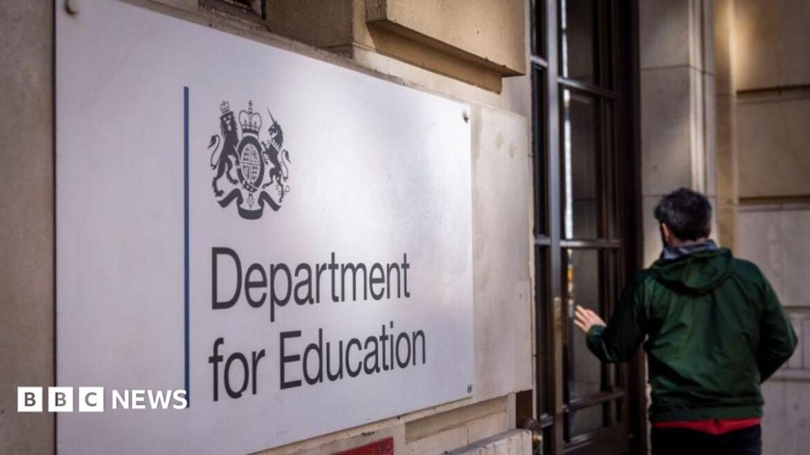 The Department for Education sign on a white brick building