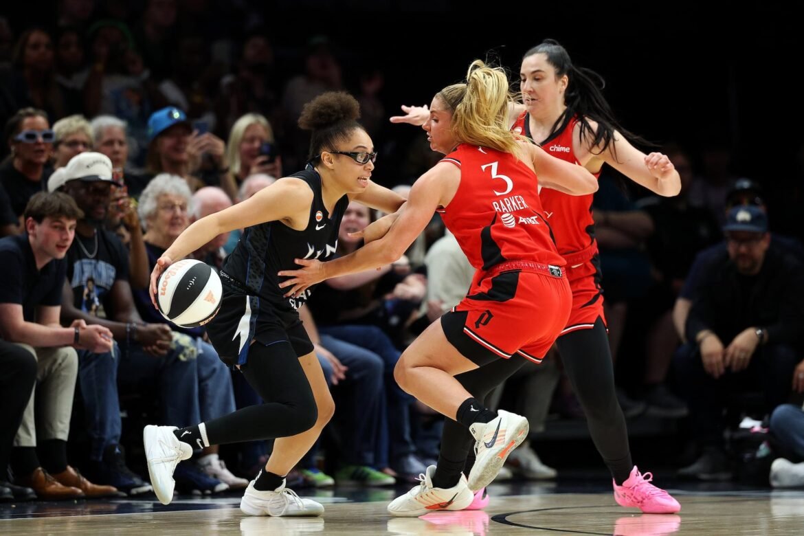 Olivia Miles #5 of the Minnesota Lynx dribbles the ball against Sarah Ashlee Barker #3 and Megan Gustafson #17 of the Portland Fire in the third quarter at Target Center on June 15, 2026 in Minneapolis, Minnesota. The Lynx defeated the Fire 107-74.