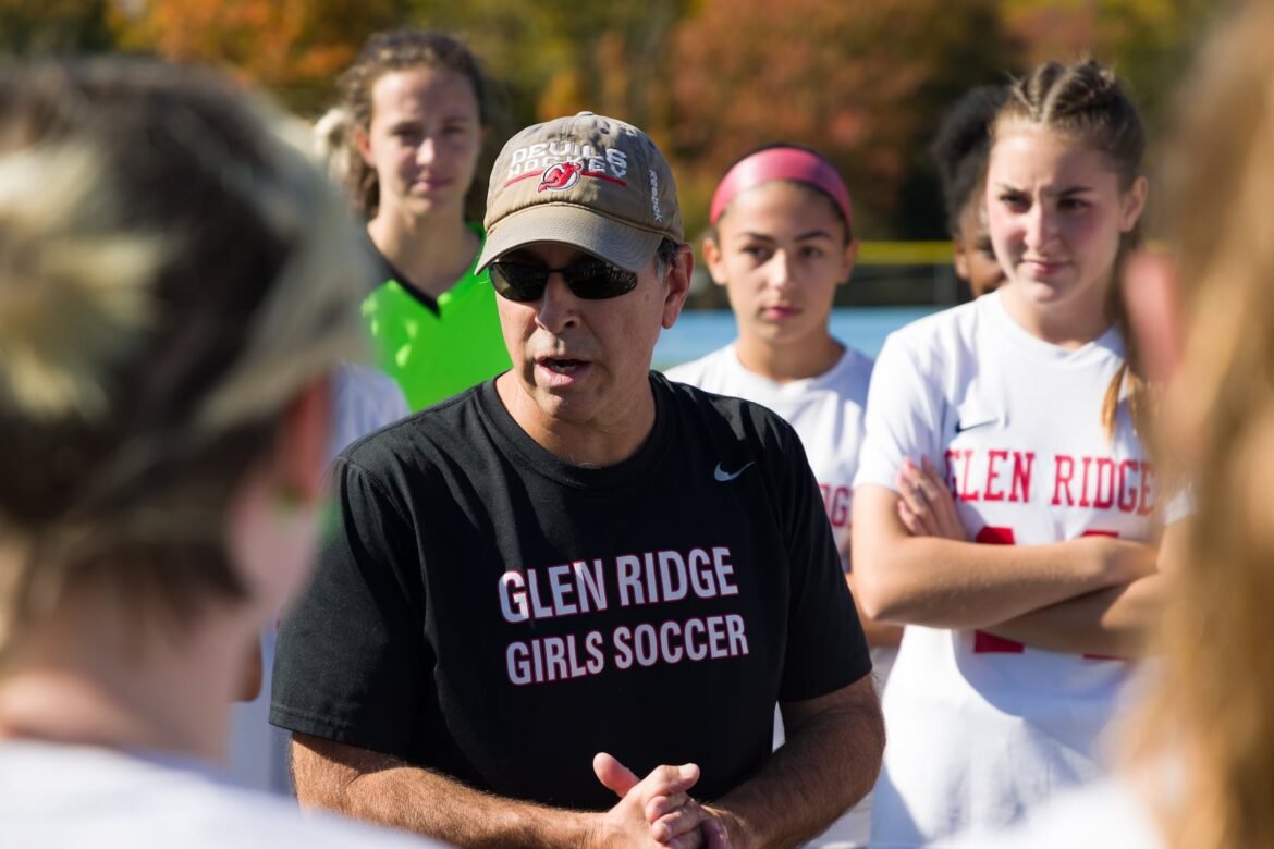 Glen Ridge head coach Oscar Viteri strategizes with his team during Saturday's Essex County girls high school soccer final in West Caldwell.  West Orange took out the Ridgers 5-0.  10/22/2022