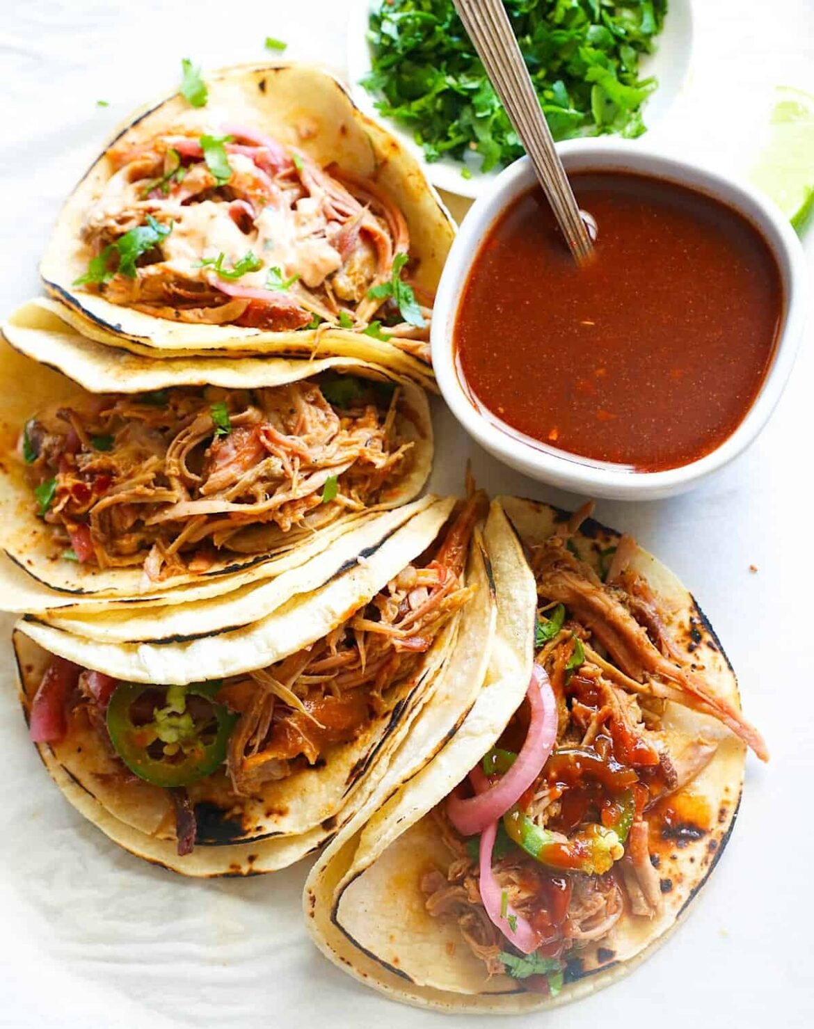 Getting ready to dive into spicy, comforting smoked pulled pork tacos with hot sauce.