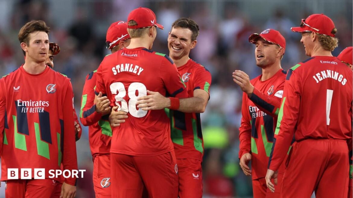Jimmy Anderson (centre) is hugged by Mitch Stanley (STANLEY 38) with other Lancashire fielders around them after getting the wicket of Joe Root