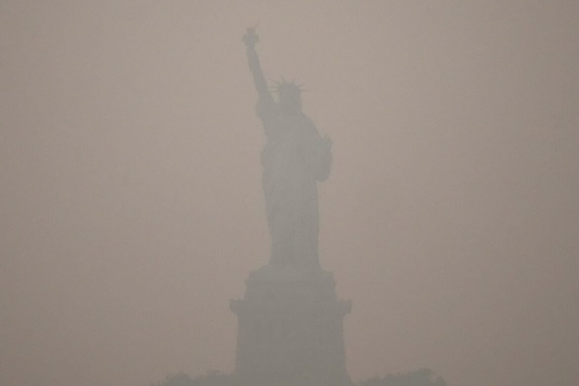 The Statue of Liberty stands during sunset as smoke from wildfires blankets the sky Thursday in the Brooklyn borough of New York. Smoke from Canadian wildfires blankets parts of the United States as scientists point to a combination of climate conditions, drought and extreme weather as major factors driving increasingly intense fire seasons. (AP Photo/Yuki Iwamura)