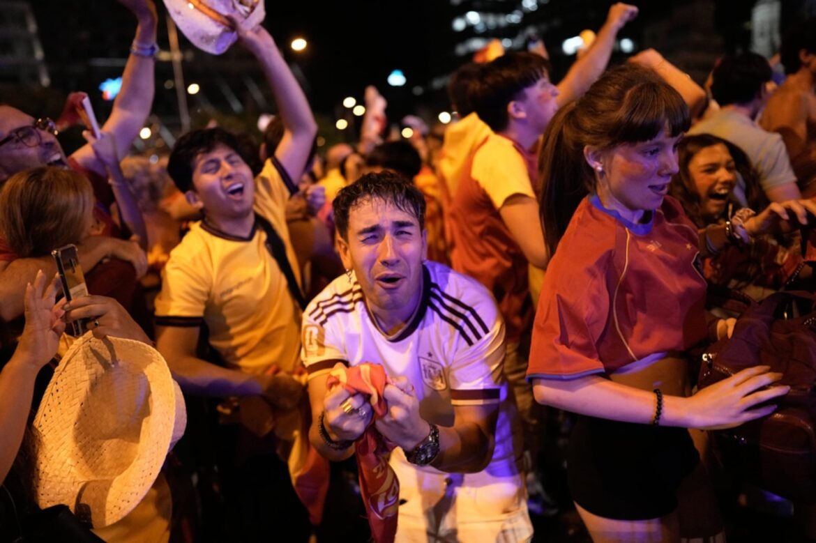 Spanish fans celebrate in central Madrid after Spain's Ferran Torres scores his team's first goal during the World Cup final soccer match against Argentina in East Rutherford, N.J., near New York, Sunday, July 19, 2026. (AP Photo/Bernat Armangue)