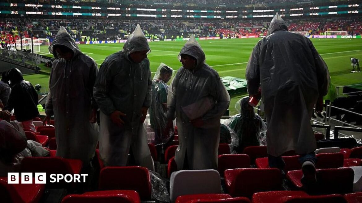 Fans wearing rain ponchos are seen in the stands ahead of the 2026 World Cup round of 32 football match between Mexico and Ecuador