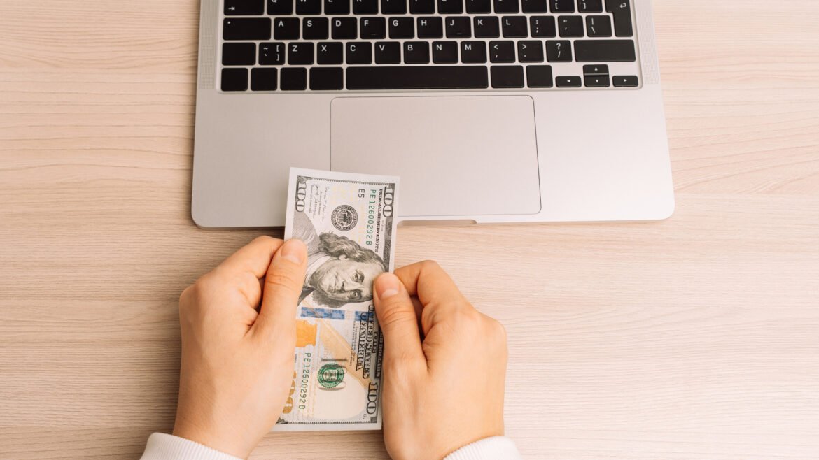 an image of money and laptop