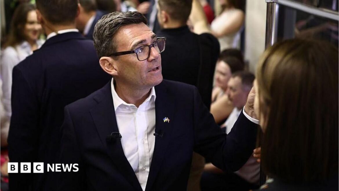 Andy Burnham reacts as he stands in a metro carriage among passengers during the journey between the metro stations Zoloti Vorota and Lukanivska on August 24, 2026 in Kyiv, Ukraine.