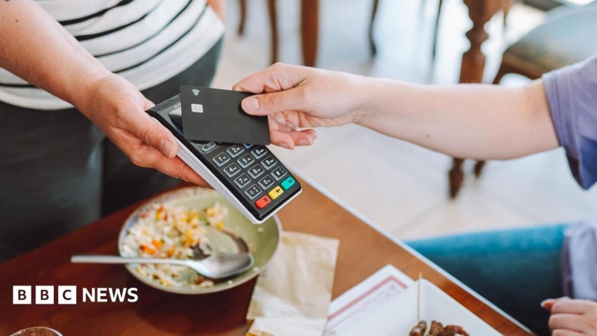 A person pays with a credit card in a restaurant