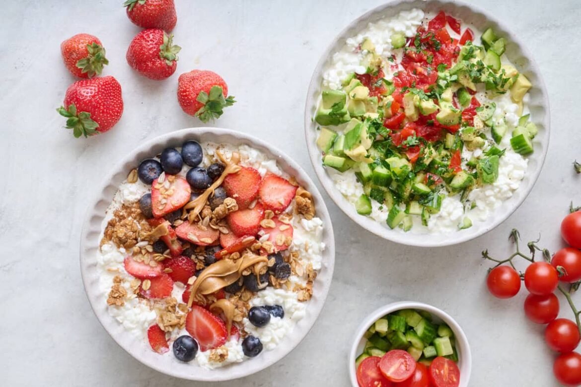 Two cottage cheese bowls, one with savory toppings including chopped veggies, herbs, salt and pepper. The other bowl with sweet toppings including fresh fruit, granola, and peanut butter.