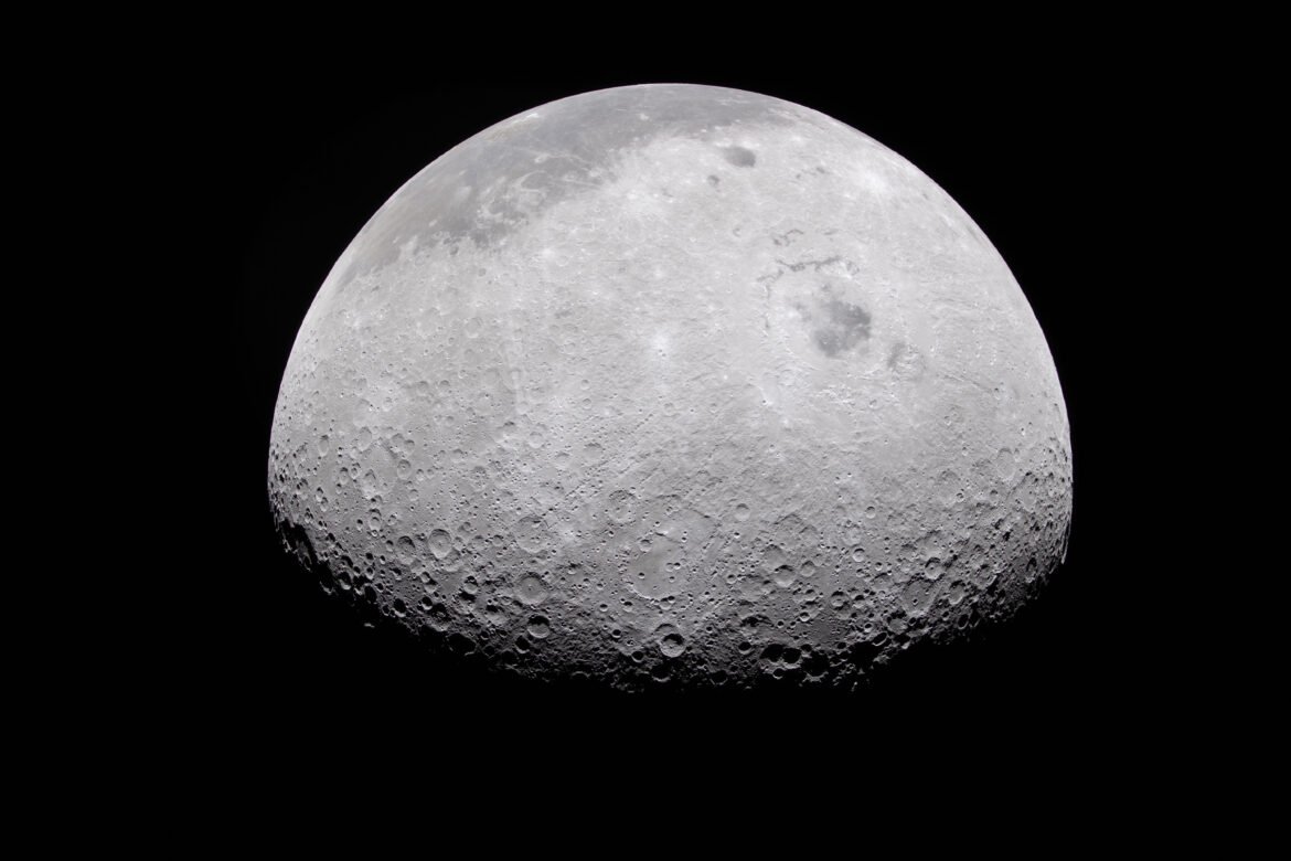 The Moon's rugged surface is on display in this image. Most of the Moon is visible, with the bottom of the sphere disappearing into the darkness. This line between light and dark is called the terminator. The terminator is lined with many craters.