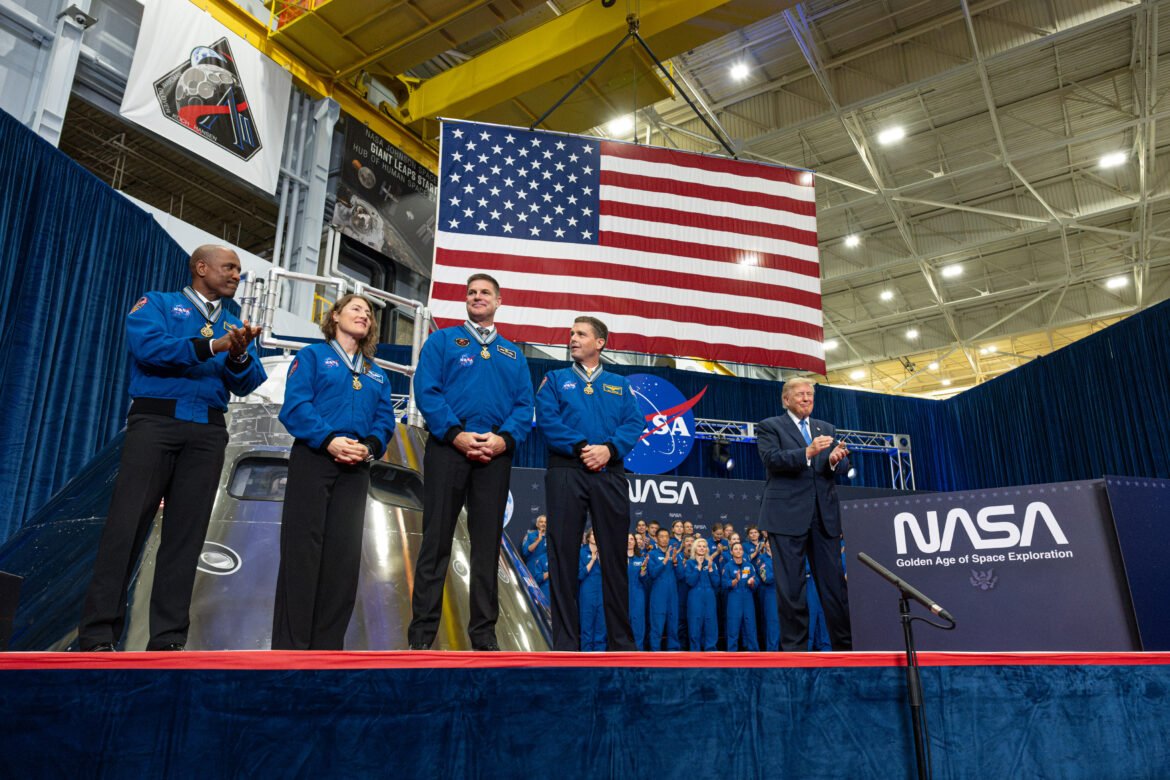 The four members of the Artemis II mission stand on stage after receiving the Congressional Space Medal of Honor. To their right is President Trump.