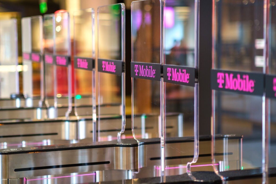 T-Mobile-branded clear barrier gates that employees must pass through with a badge.