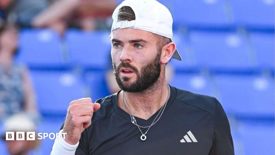 Jacob Fearnley clenches his fist in celebration after winning a point