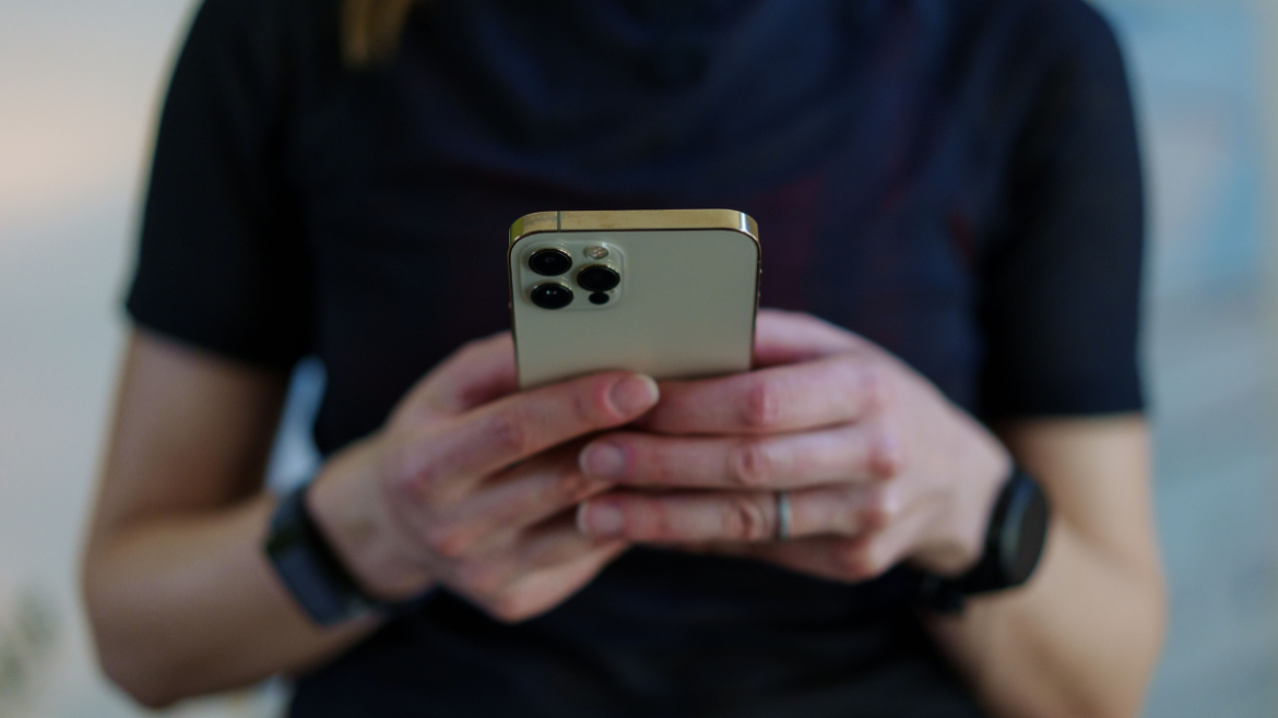 Endurance Coach Holding Her Phone And Reading An Email From One Of Her Athletes.