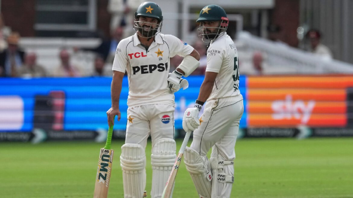 Pakistan's Mohammad Rizwan, left, stands with batting partner Saud Shakeel as they await third umpire's decision on Rizwan's wicket on day four of the second cricket test match between England and Pakistan in London, Sunday, Aug. 30, 2026. (AP Photo)