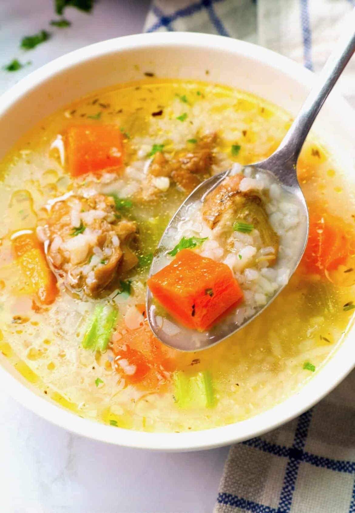 Enjoying comforting chicken soup with rice and vegetables, perfect for a winter day or bout with the flu.