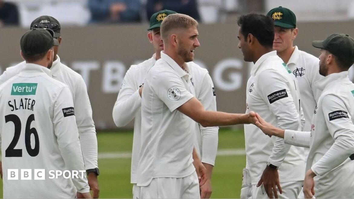 Olly Stone celebrates taking a wicket with his Notts team-mates