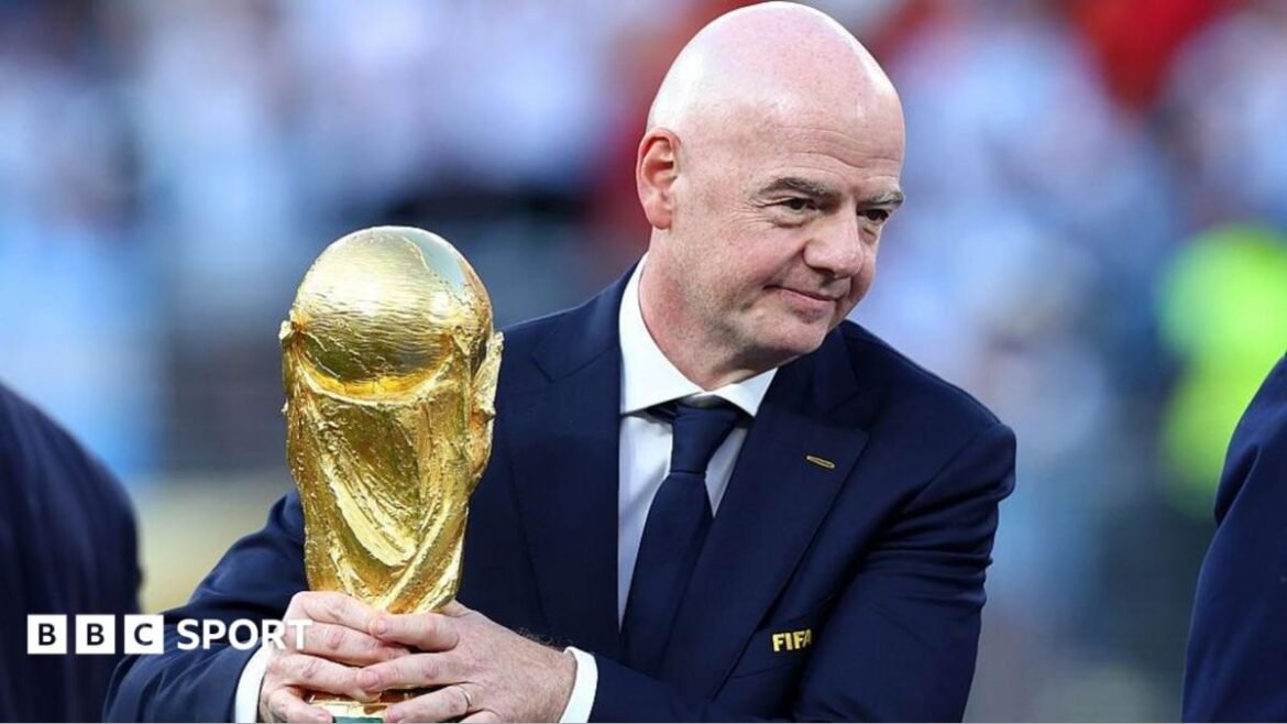 Gianni Infantino holding the World Cup trophy