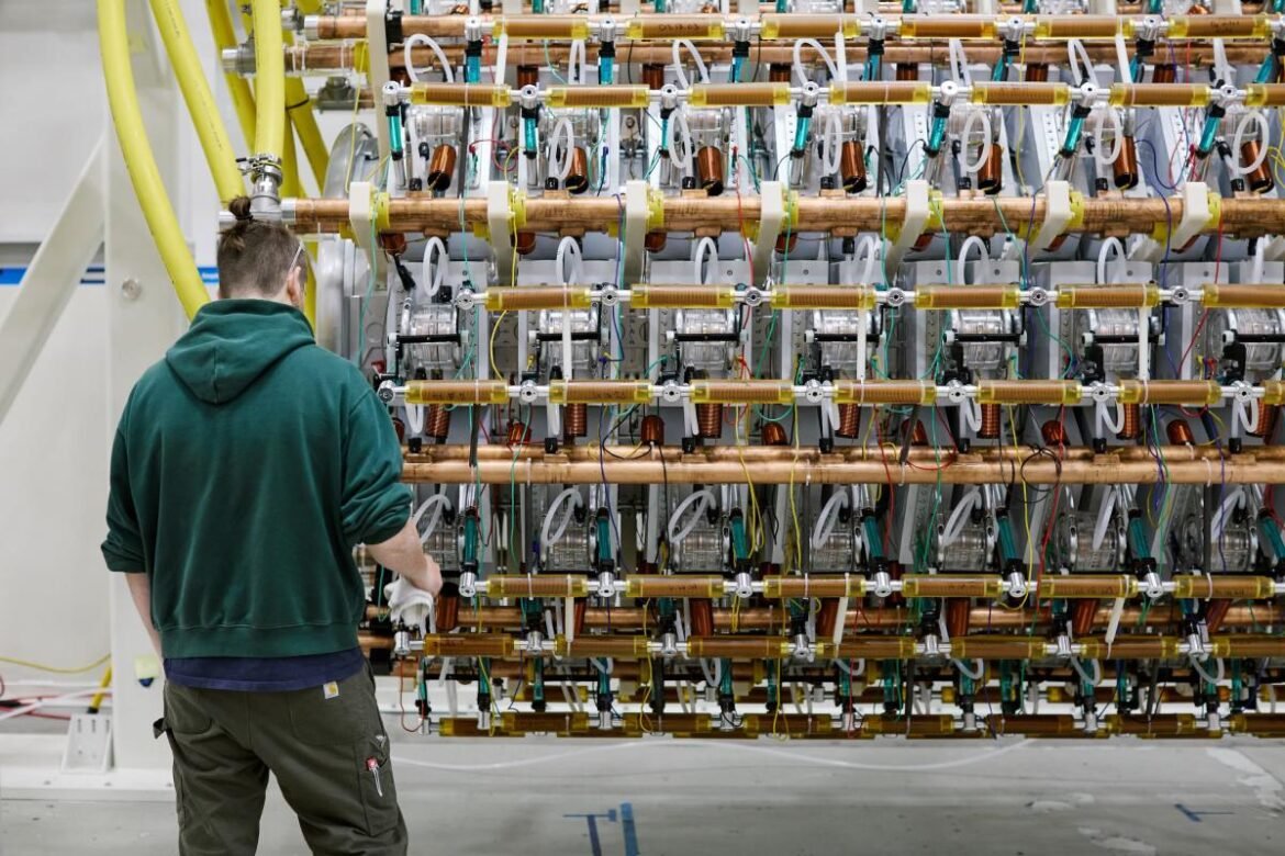 A man works on Pacific Fusion's pulser prototype.