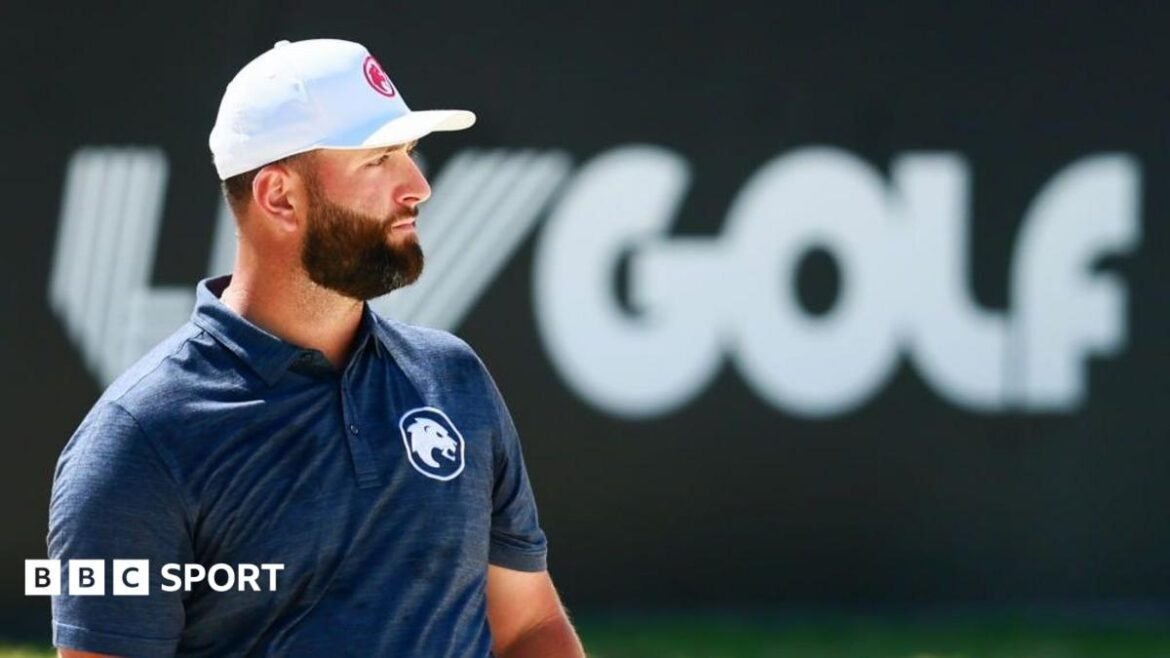 Golfer Bryson DeChambeau putts in front of a big blue and white LIV Golf sign
