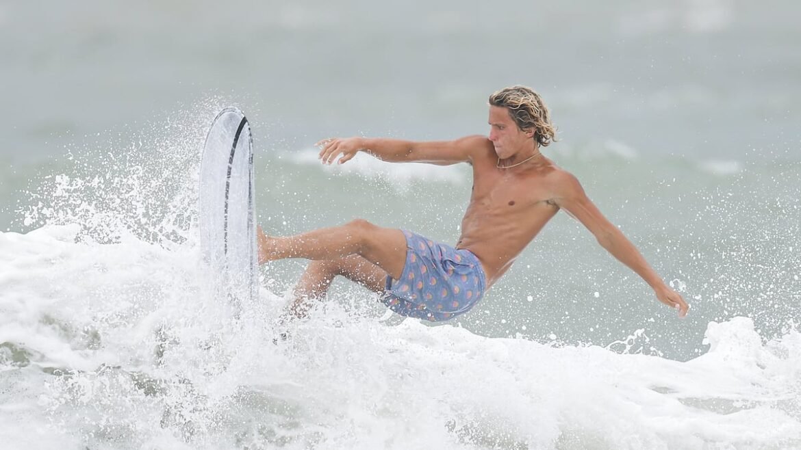 Despite warnings, surfers ride waves stirred up by Hurricane Isaias at Sunset Beach