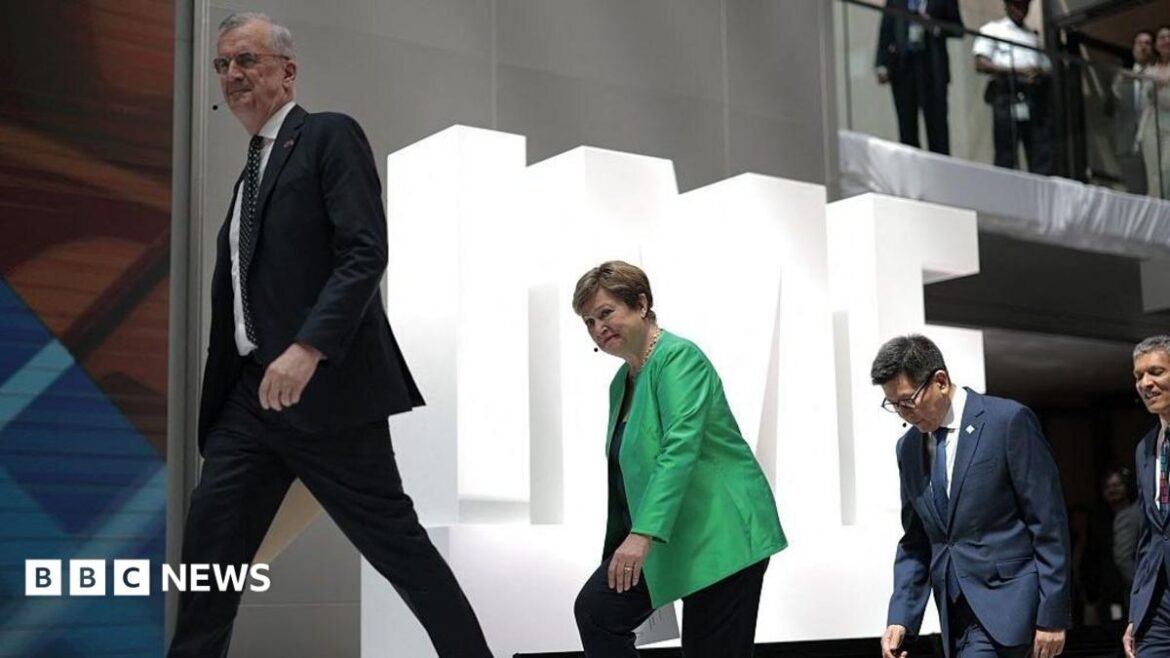 Three people walking up stairs one behind each other against a backdrop of white letters spelling IMF. 