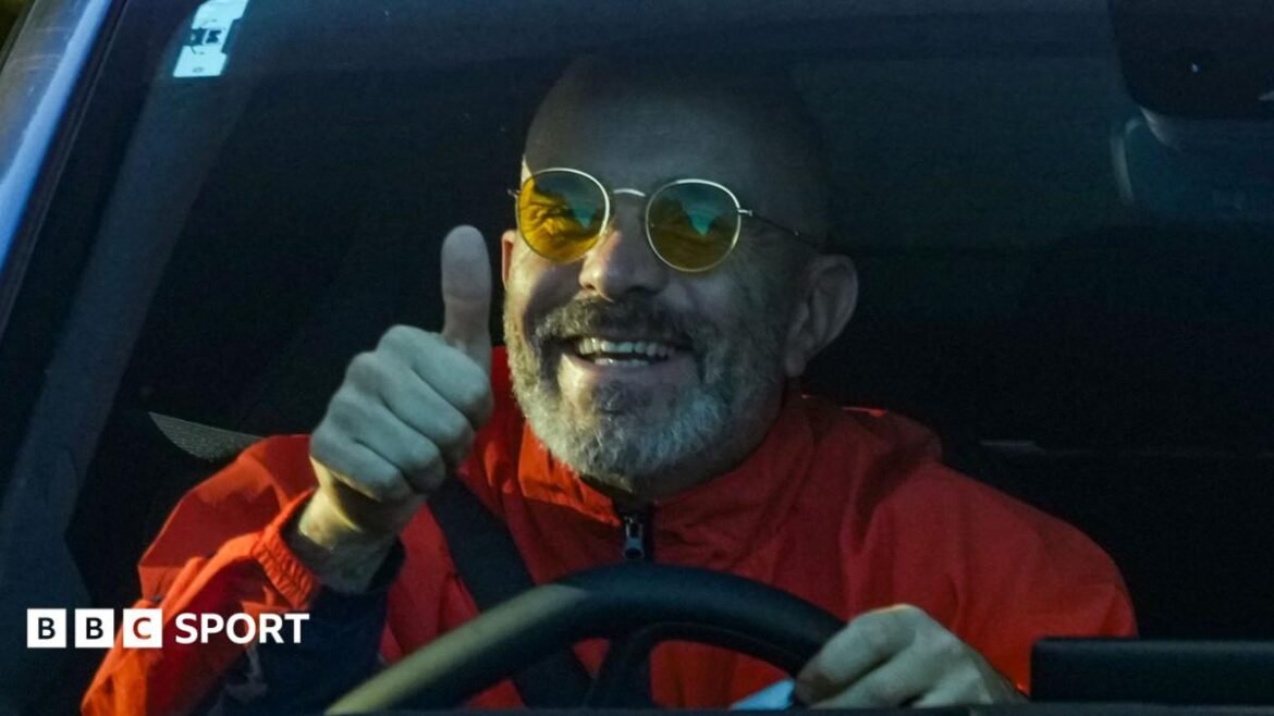 Manchester City manager Enzo Maresca gives a thumbs-up as he arrives at the City Football Academy in his car