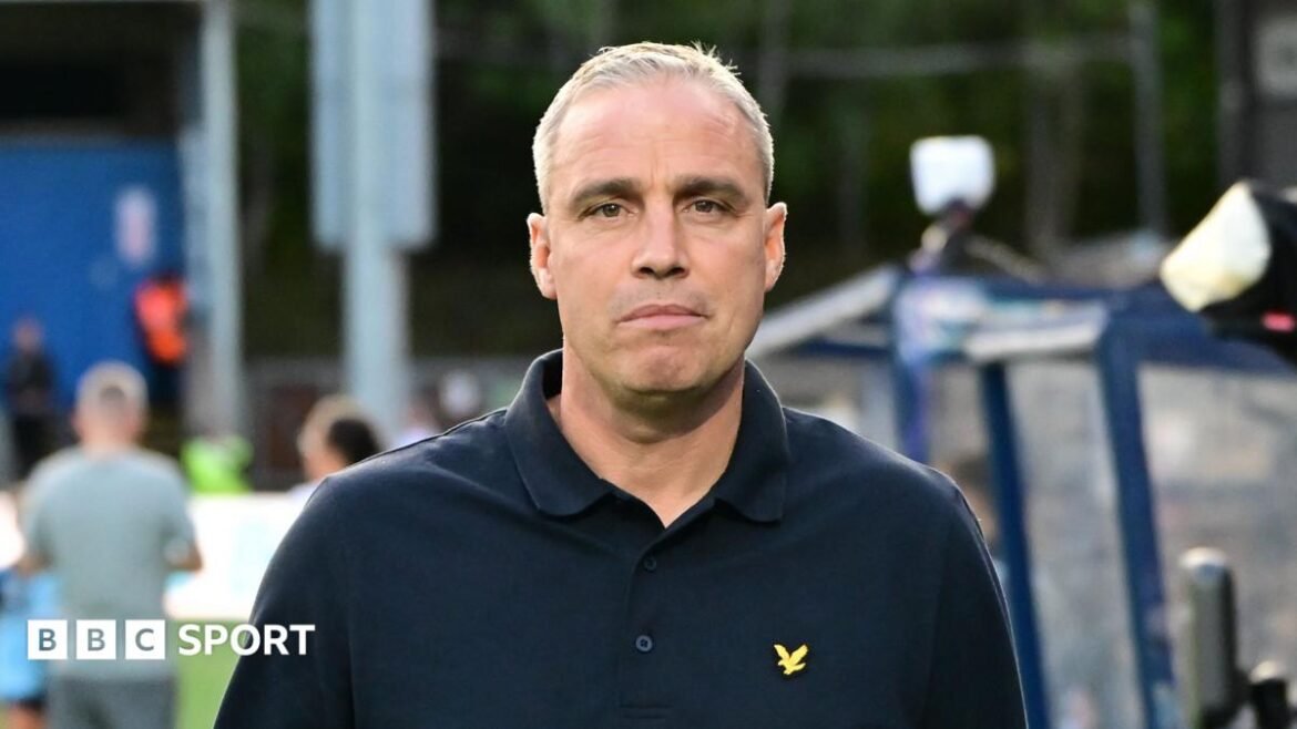 Michael Duff, wearing a dark buttoned top, during his time as Wycombe Wanderers manager