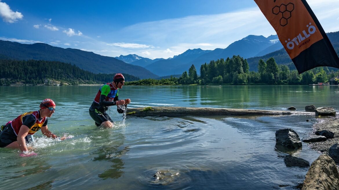 A swimrun athlete exits the water onto the run portion of the event.
