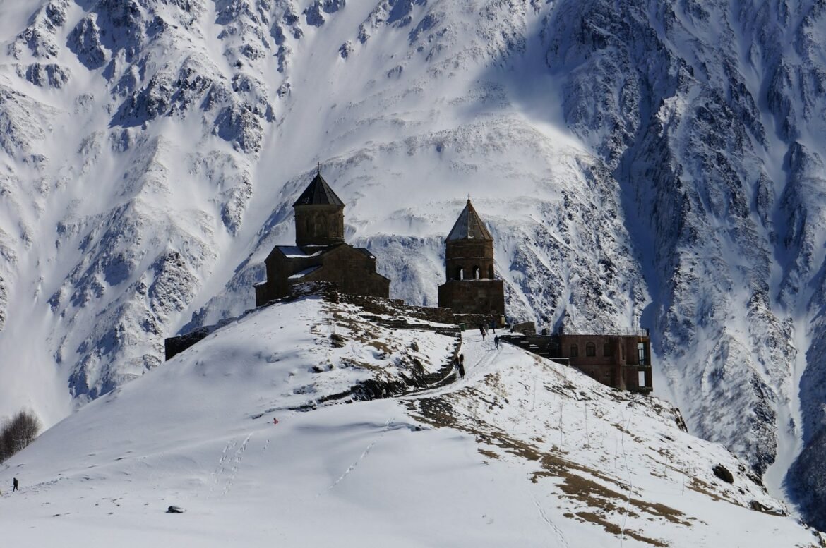 Mkinvartsveri monastery on top of a snowy peak in Georgia