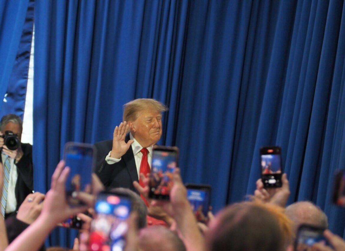 President Donald Trump waved to supporters gathered at the Sioux Gateway Airport in Sioux City Oct. 22, 2026, for a rally supporting Iowa Republicans in the upcoming midterm elections. (Photo by Robin Opsahl/Iowa Capital Dispatch)